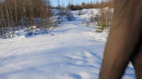Man walks through deep snow in the winter forest Video stock 72641787