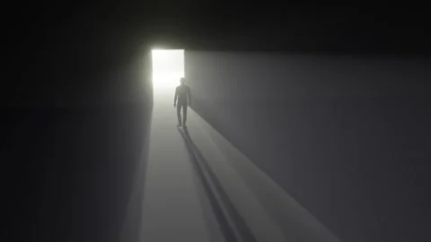 Man walks through a door into the light with mist Stock Footage 284542313
