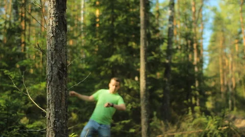 A man walks through the forest with smart watch and looking at the navigation Stock Footage 65021063