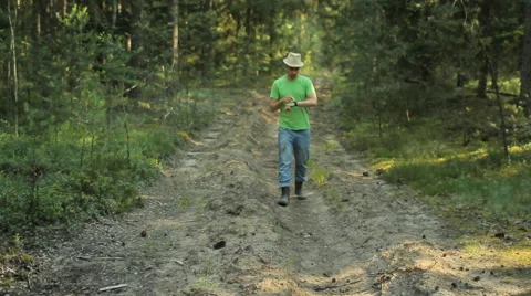 A man walks through the forest with smart watch and looking at the navigation Stock Footage 65021340