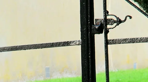 Man Walks through an iron gate Stock Footage 37554129
