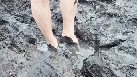 Man walks through the mud Video stock 247407255