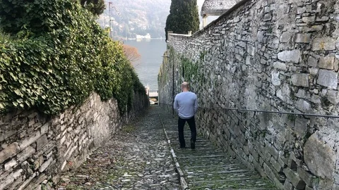 A man walks through the old town on lake Como Stock Footage 122109074