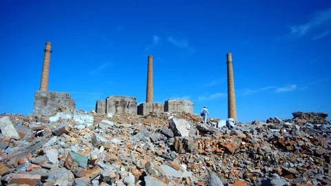 Man walks through the ruins of an old factory Stock Footage 90603200
