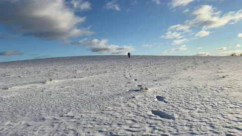 A man walks through the snow in a field in frosty weather. Stock Footage 171000341