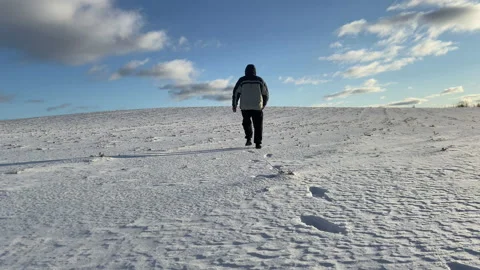 A man walks through the snow in a field in frosty weather. Stock Footage 171002470