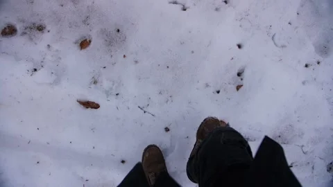A man walks through the snow in his boots. First person view. Stock Footage 232722863