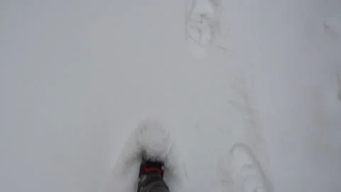 A man walks through the snow in summer sneakers Video stock 104864368