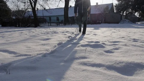 A man walks through the snow in the winter. The countryside in winter Stock Footage 77207117