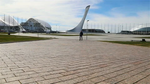 A man walks through the Sochi Olympic Park Stock Footage 132653267