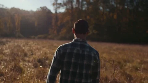 Man Walks Through Wheat Field During Sunrise (Tracking) Stock Footage 81491936