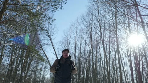 A man walks through winter forest in sunny day, Steadycam shot Stock Footage 86893284