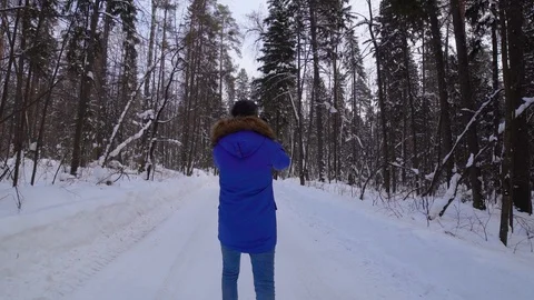 A man walks through the woods and taking photos. Steady cam shot Stock Footage 102775592