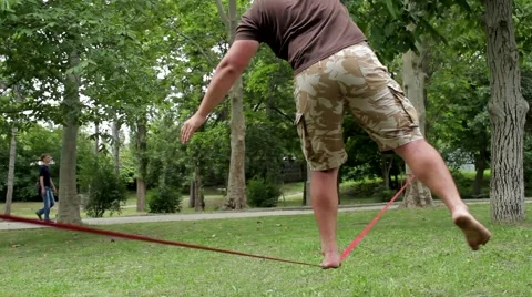A man walks a tightrope 스톡 동영상 53780398