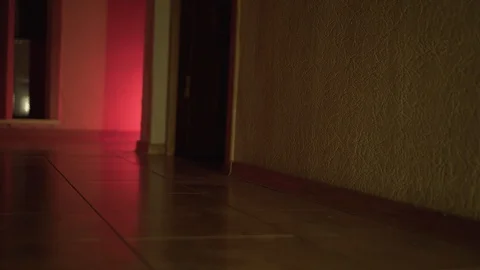 A man walks on the tile in the apartment in the dark. Stock Footage 107961115
