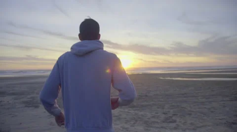 Man walks toward the ocean Stock Footage 59903355