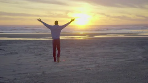 Man walks toward sunset Stock Footage 59922606