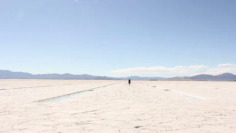 Man Walks Towards Camera on Salt Flats Stock Footage 71982471