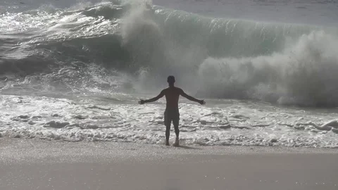 Man Walks Towards Massive Crashing Wave Slow Motion Stock Footage 106784530