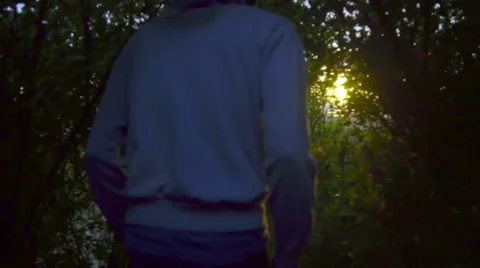 Man walks towards the sunset Stock Footage 59866617