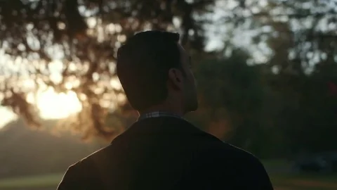 Man Walks Under Trees During Morning Sunrise Stock Footage 81492089