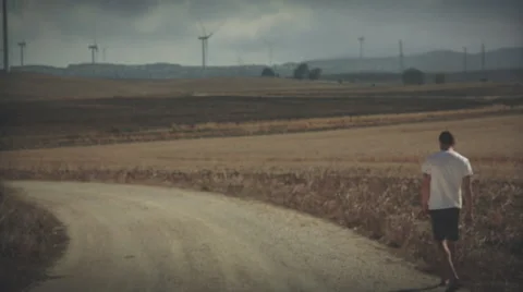 Man walks in windmillpark Spain, graded Stock Footage 57360373