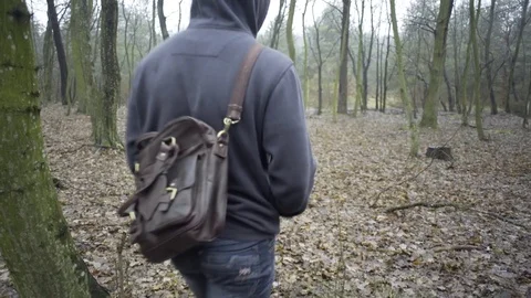 A man walks in the Woods and looking for a way Stock-Footage 71955141