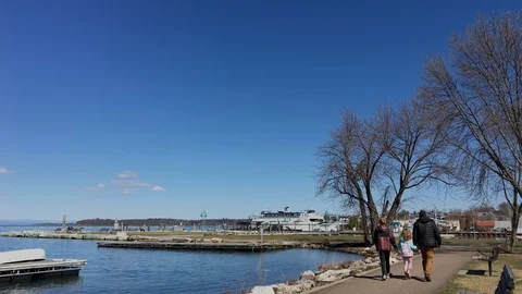 Man Walks with Young Son and Daughter Along Edge of Lake Champlain Stock Footage 89301403