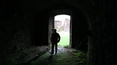 A man wanders into a dark room or place Stock Footage 40475677