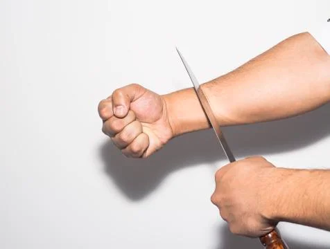 Man want to commit suicide by cutting his veins with knife on white backgroun Stock Photos