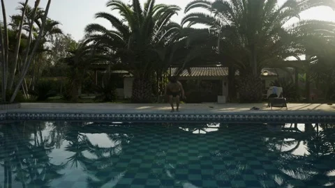 A man wanting to jump into the pool and gets scared but taking courage he jumps Video stock 170023106