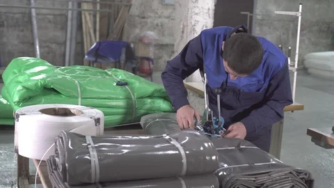 Man warehouse worker is engaged in the packaging of plastic awning Stock Footage 97849967