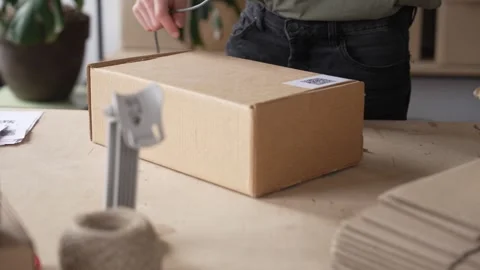 A man warehouse worker online store owner preparing parcel boxes checking e Stock Footage 272392091