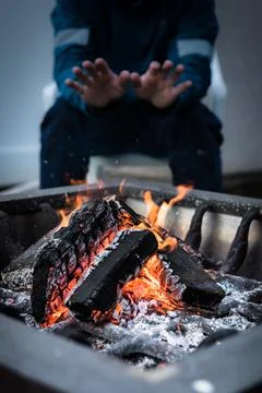 Man Warming Up By A Fire From The Cold Portrait Stock Photos