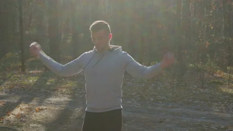 Man Is Warming Up In Forest Making Arm Circles Stock Footage 165826754