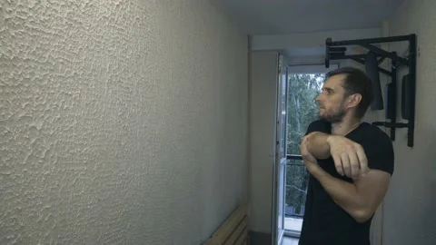 A man is warming up in the hallway. Stock Footage 155463994