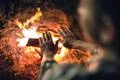 The man warming hands near the bonfire. night time Photo