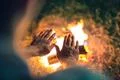 The man warming hands near the bonfire. night time Photo