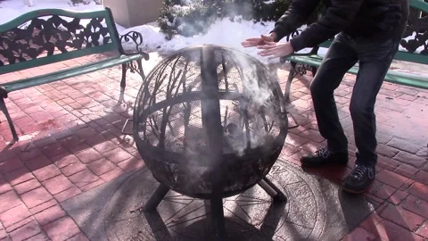 Man Warming Hands by Public Fire Pit 動画素材 233469959