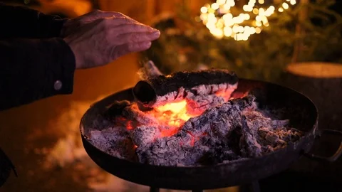 Man warming her hands on the fire Stock Footage 123697474