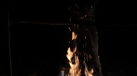 Man warming himself campfire on a cold night of camping. Stock Footage 63951389