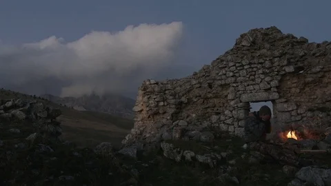 Man Warming His Hands in the cold mountains Stockbeeldmateriaal 75174396
