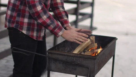 A man is warming his hands by the fire 스톡 동영상 90265758