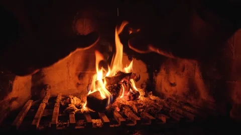 A Man Warming His Hands By The Fire From The Fireplace Stock Footage 329460249