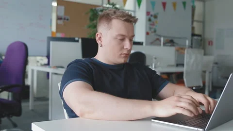 A man is warming up, pulling up after a long work at the computer Stock Footage 112601516