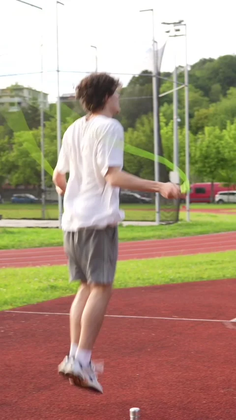 Man warming up skipping rope in an outdoor running track Stock Footage 299896588