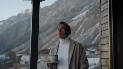 A man warms himself in the mountains with tea in his hands Stock Footage 169661323