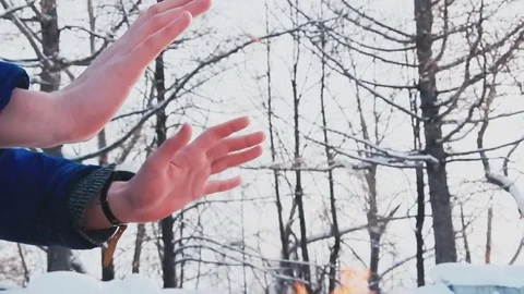 A man warms himself in the winter by the fire Stock Footage