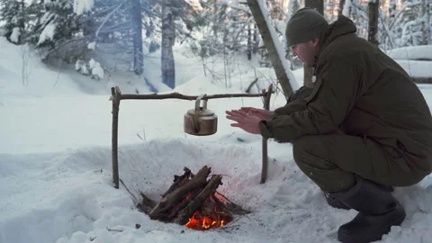 A man warms his hands by the fire in winter Stock-Footage 148150445