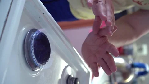 A man warms his hands over stove. Heating in winter and the gas crisis Vertical Stock Footage 198009519